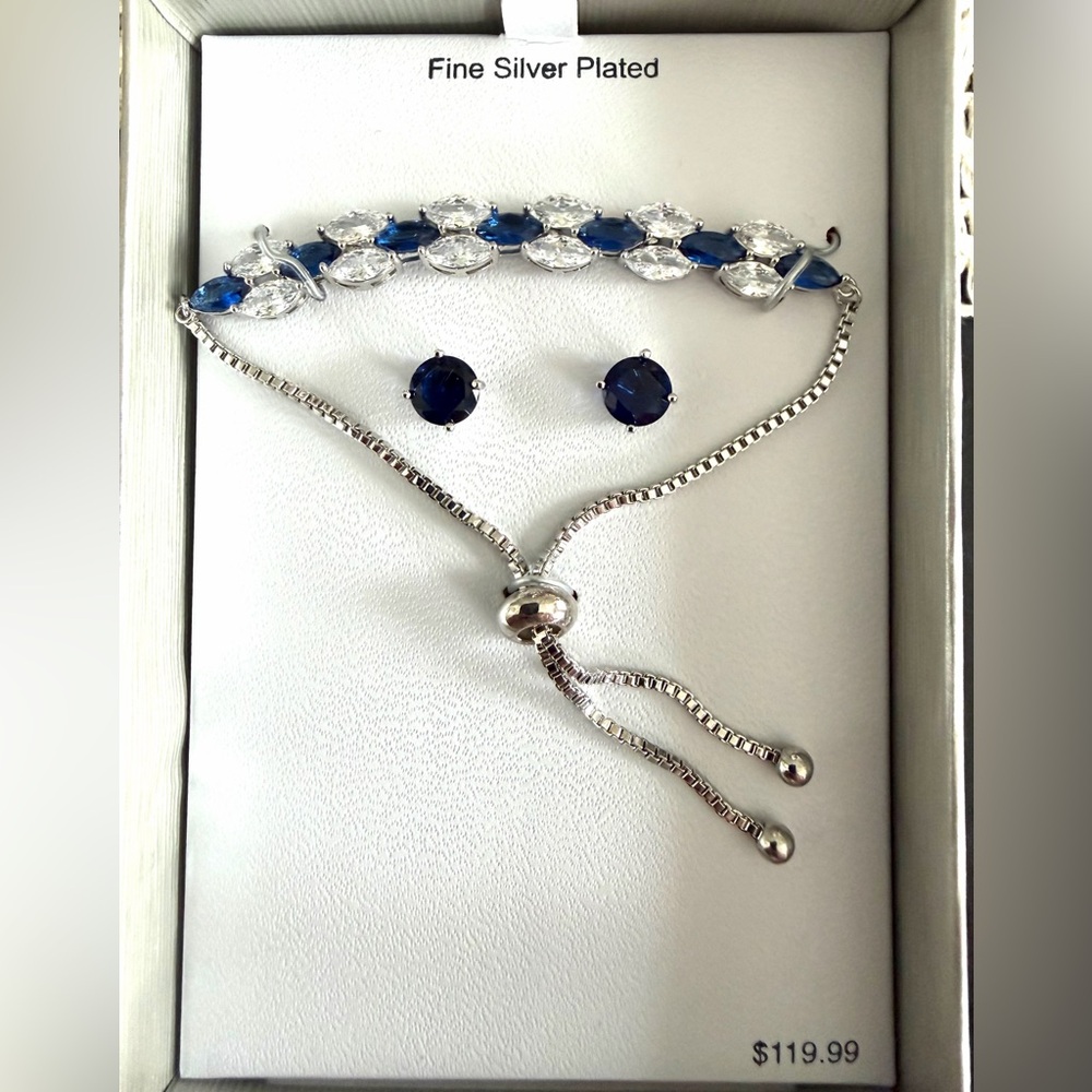 Silver plated blue and clear cubic zirconia bracelet and earring set.